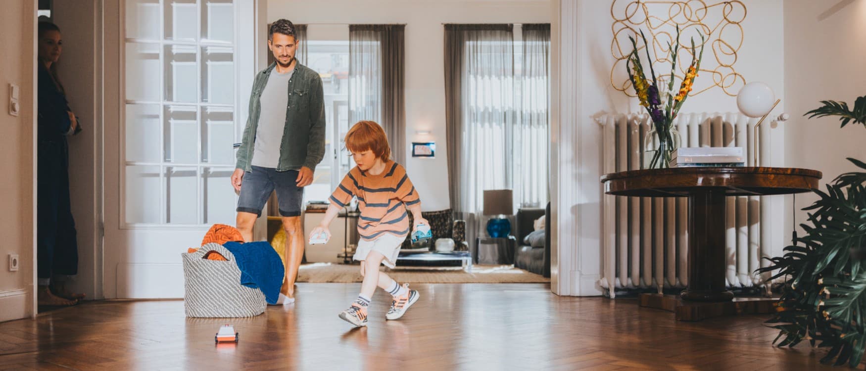 Tatal isi priveste fiul jucandu-se in sufragerie